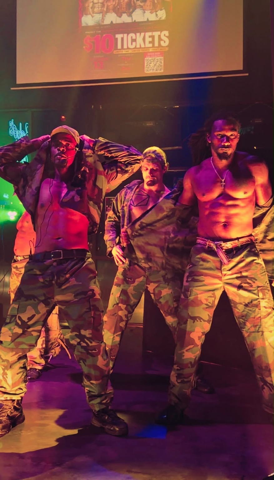 Hardbodies Live cast performing a military-inspired group routine onstage